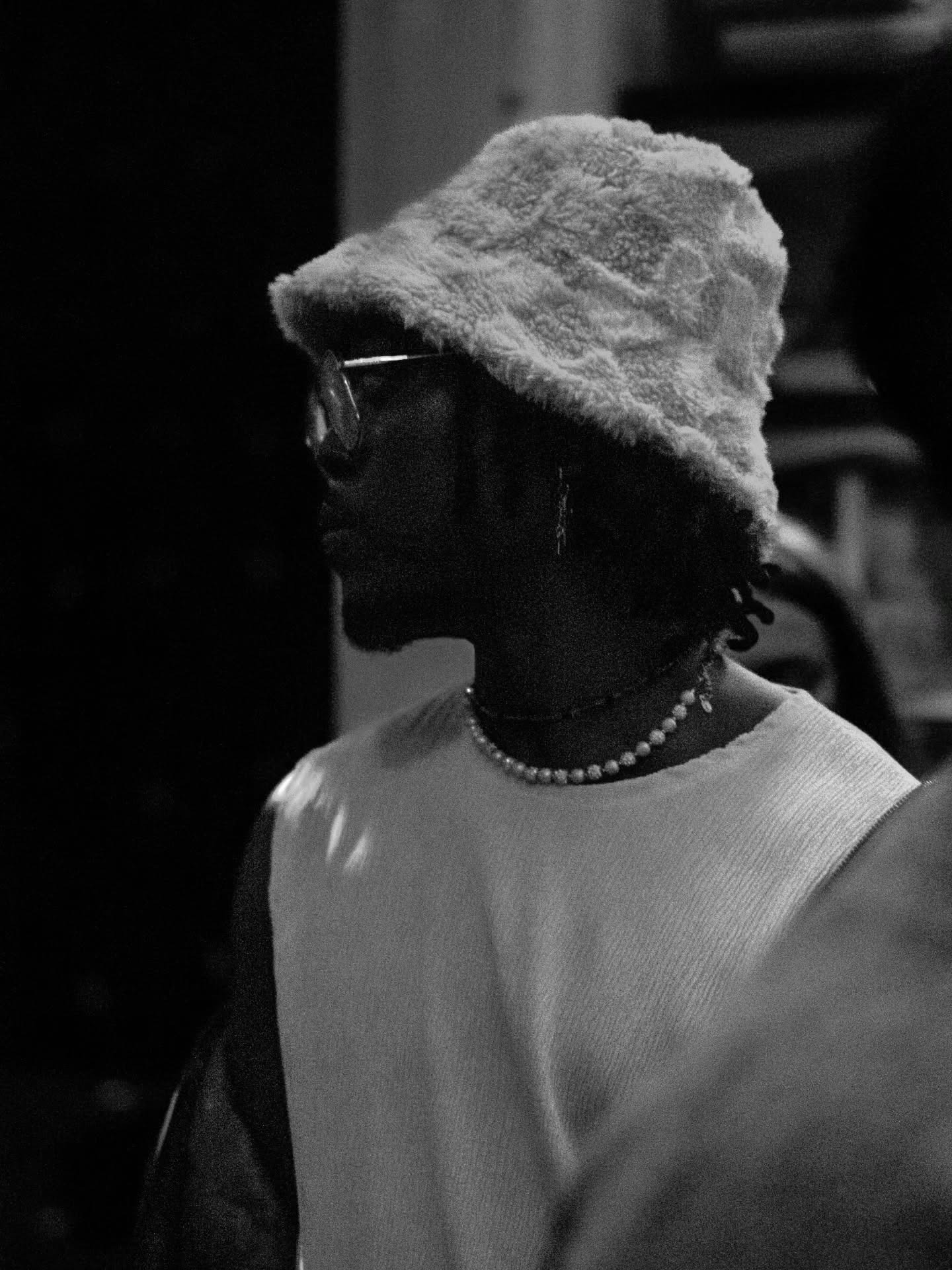 Editorial portrait in profile wearing a bucket hat