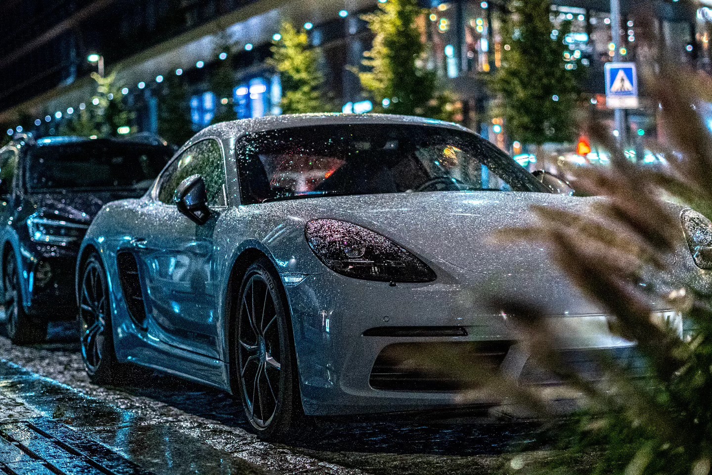 Sports car on a rainy Prague street at night