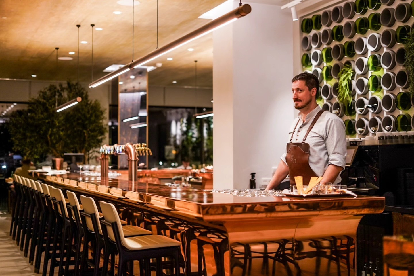 Bartender at a copper bar counter