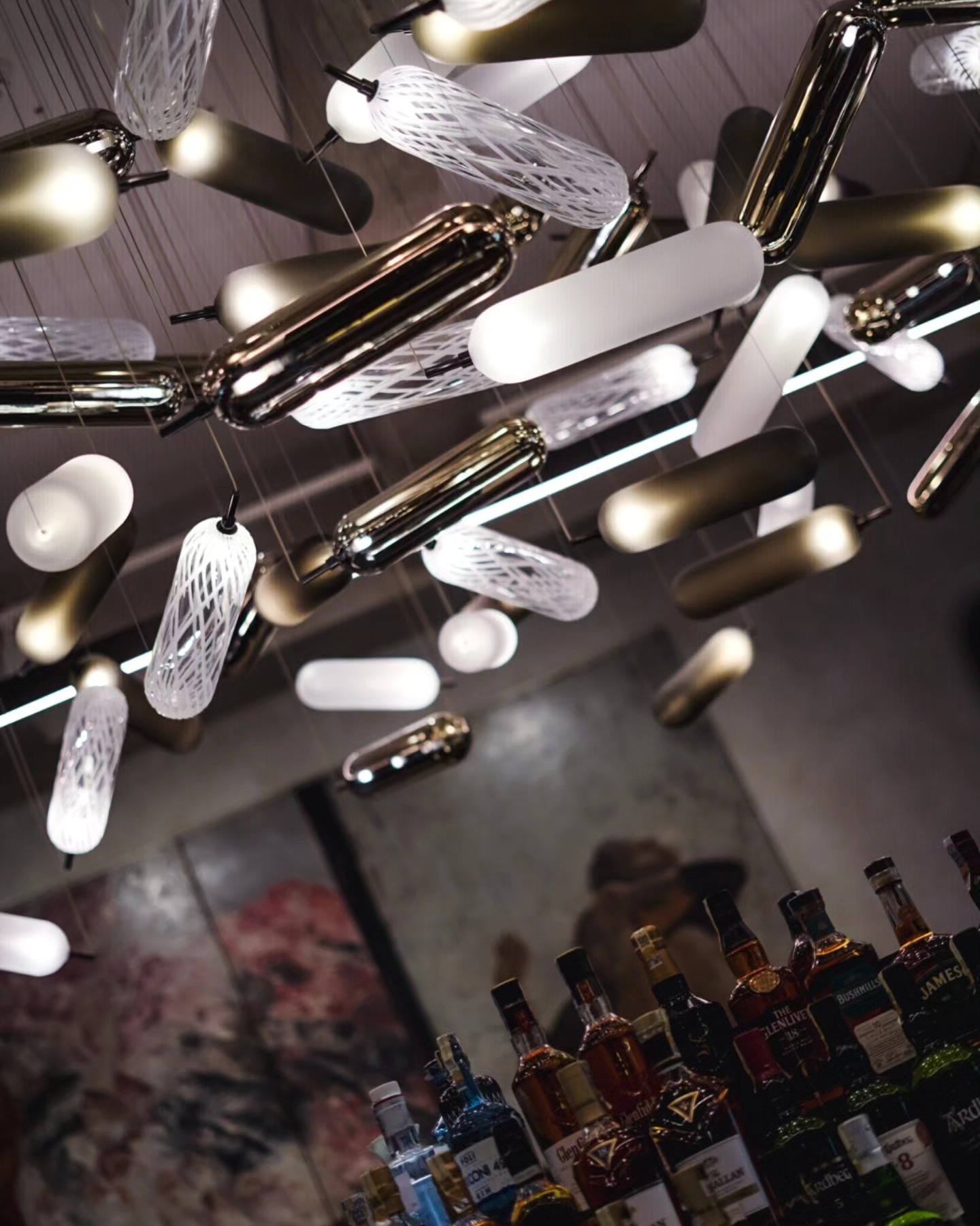Bar ceiling lighting installation and bottles