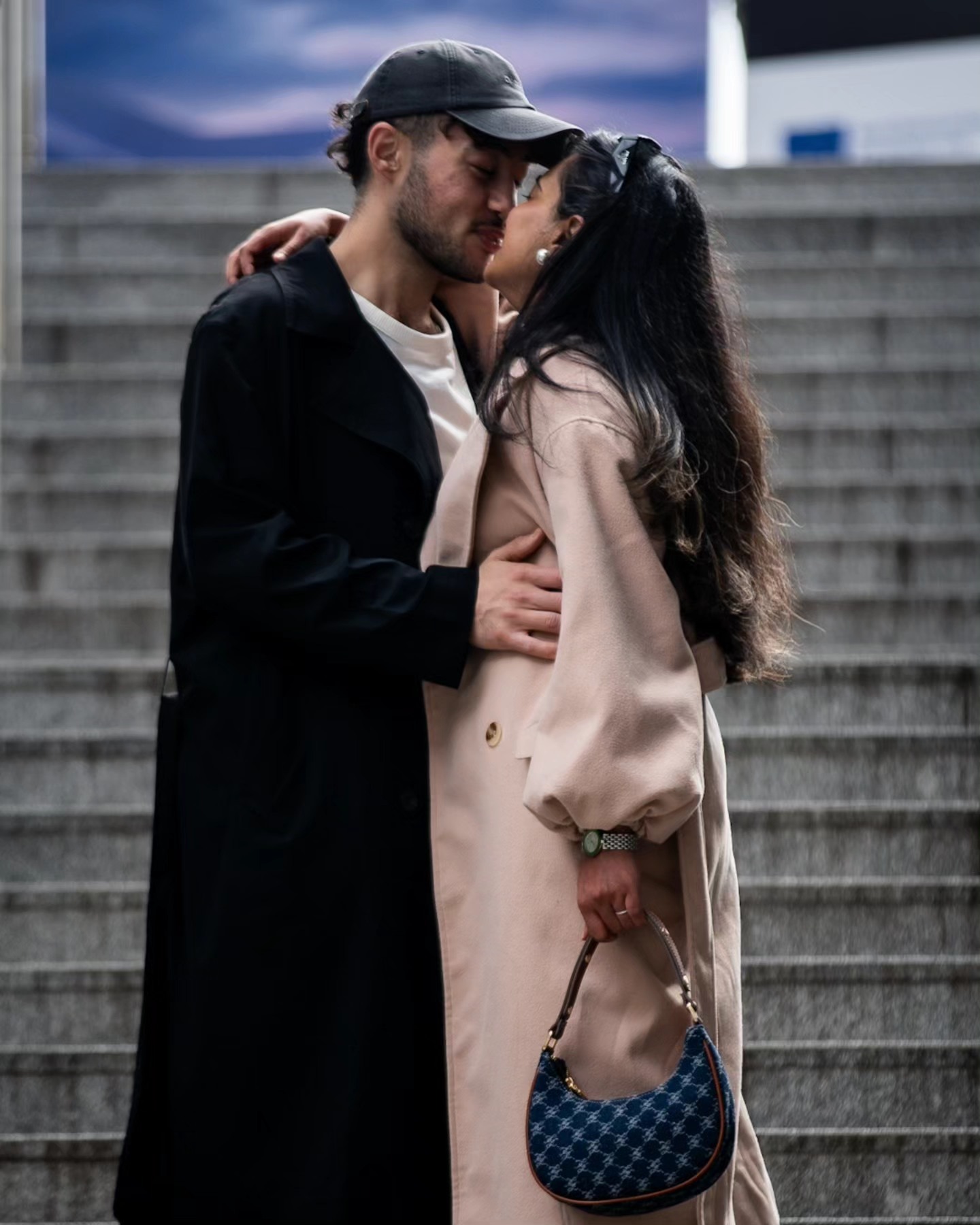Couple sharing a kiss on outdoor steps